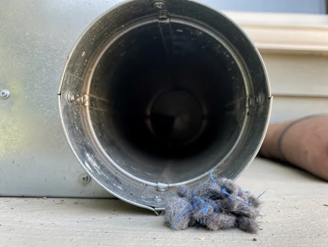 Tampa Dryer Vent Cleaning technician using specialized equipment to clear severe dryer vent blockage in Tampa